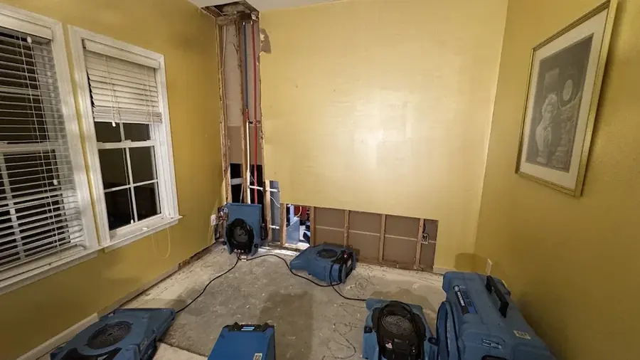 Air movers drying a room after a wall was opened in a North Dallas property