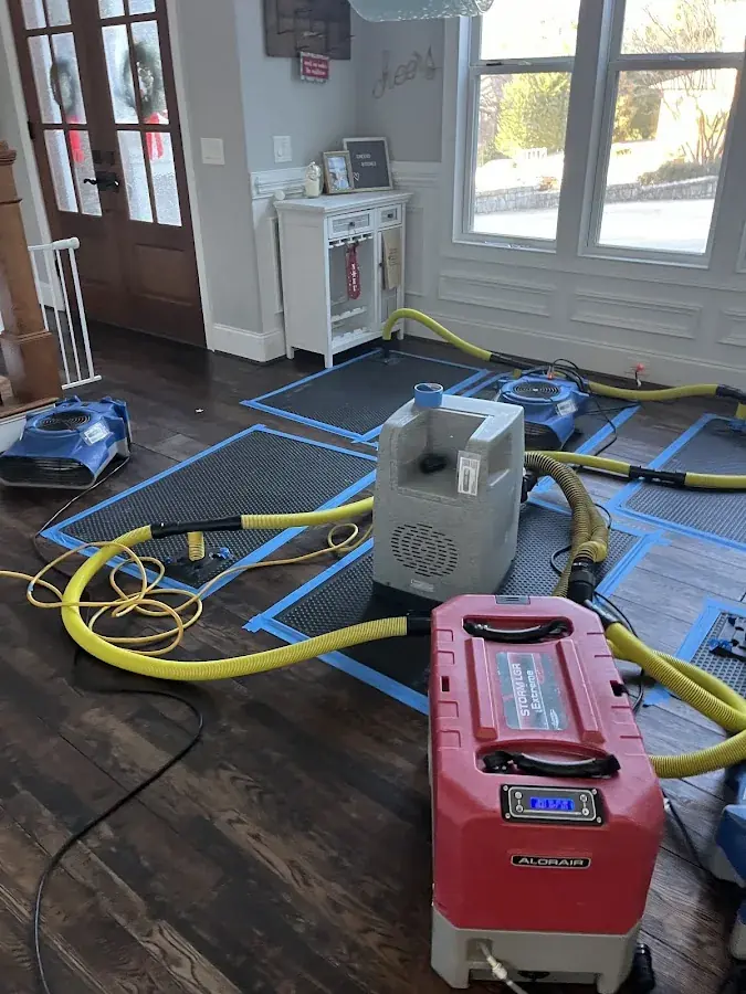 A dehumidifier staged in a water damaged room in a North Dallas property