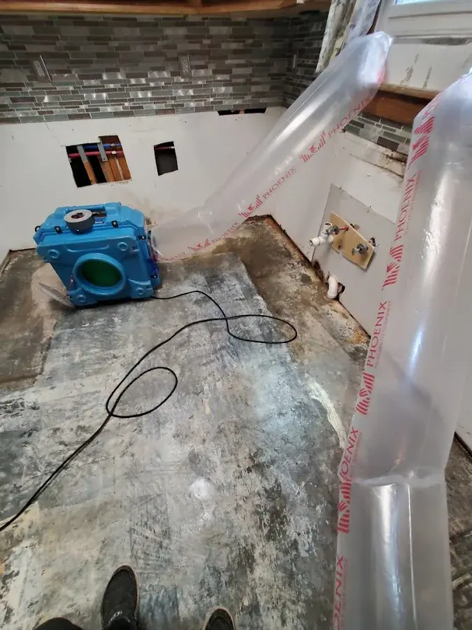 Wet kitchen flooring pulled up for drying in a North Dallas property