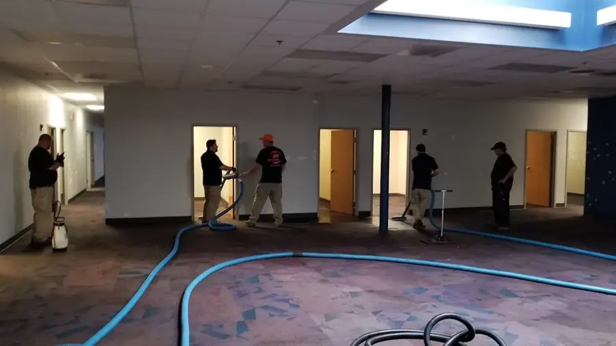 Restoration crew drying a flooded commercial building in North Dallas