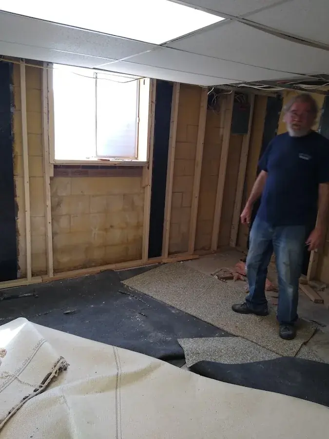 Wall opened to the studs after a frozen pipe burst in a North Dallas home