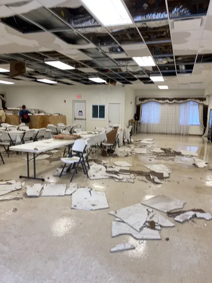 Storm water and soaked ceiling debris inside a North Dallas building