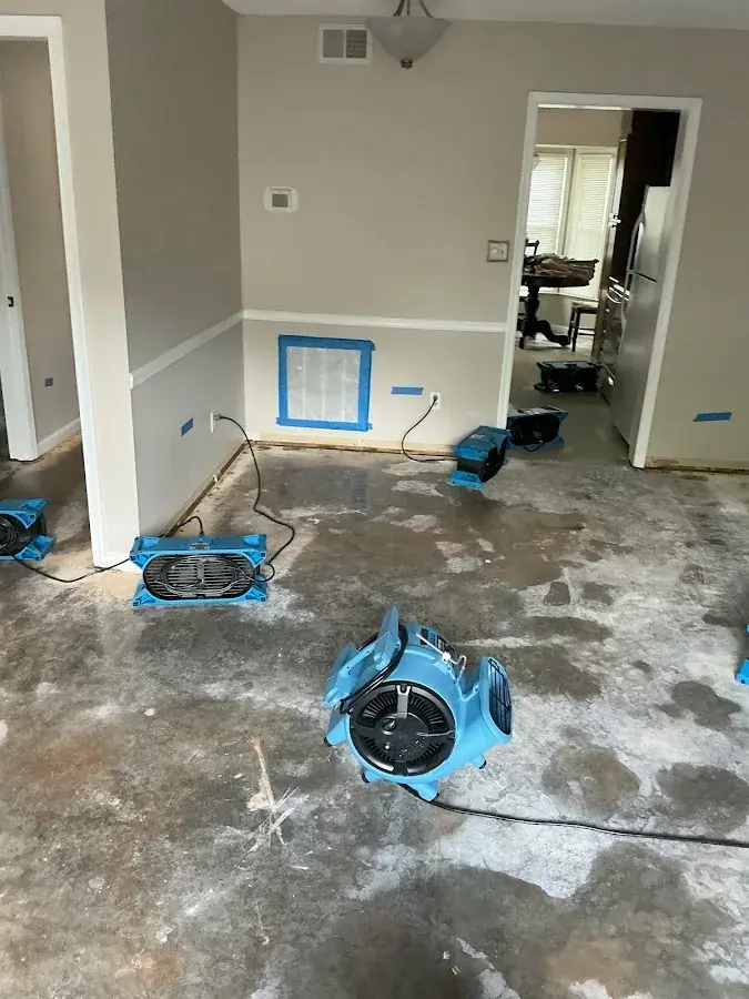 Low-profile air movers drying a concrete slab in a North Dallas property