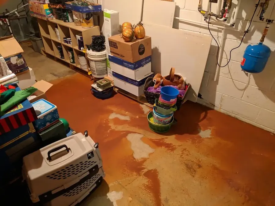 Water pooled across a utility room floor after a water heater failure